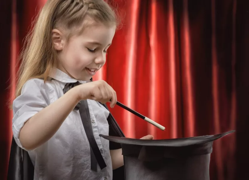 Une petite fille exécute un tour de magie