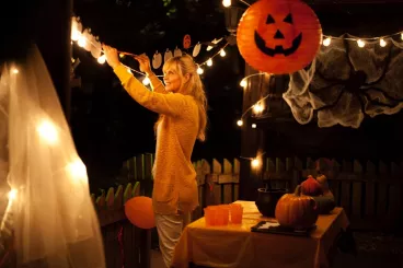 Une femme installe des décorations pour fêter Halloween