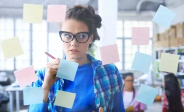 Une femme rédige des post-it