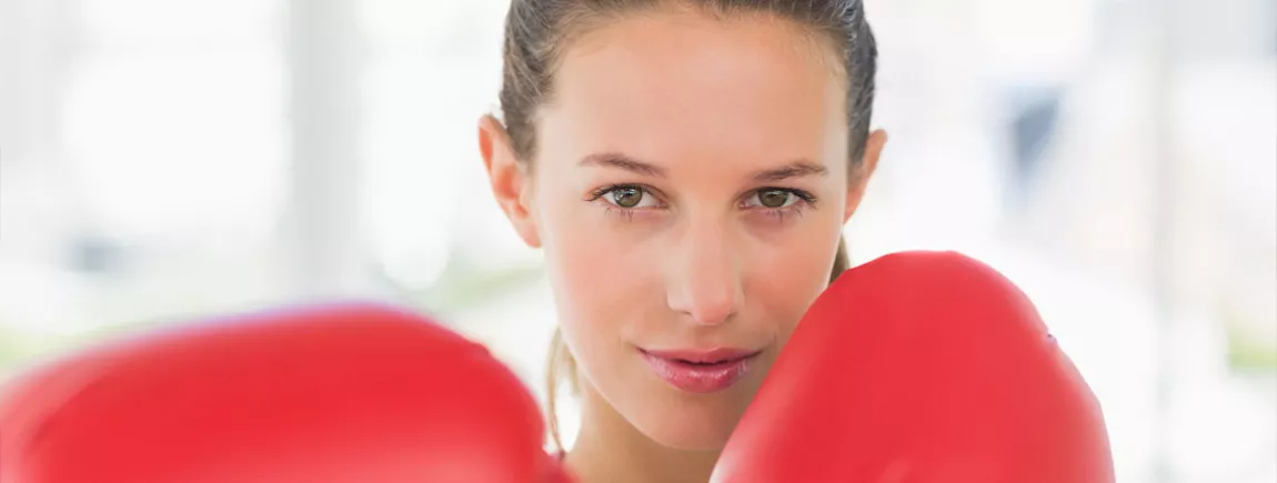 Jeune femme determinée portant des gants de boxe