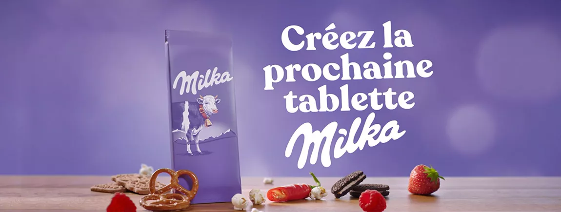 Une tablette de Milka est entourée de fraise, d’oréo