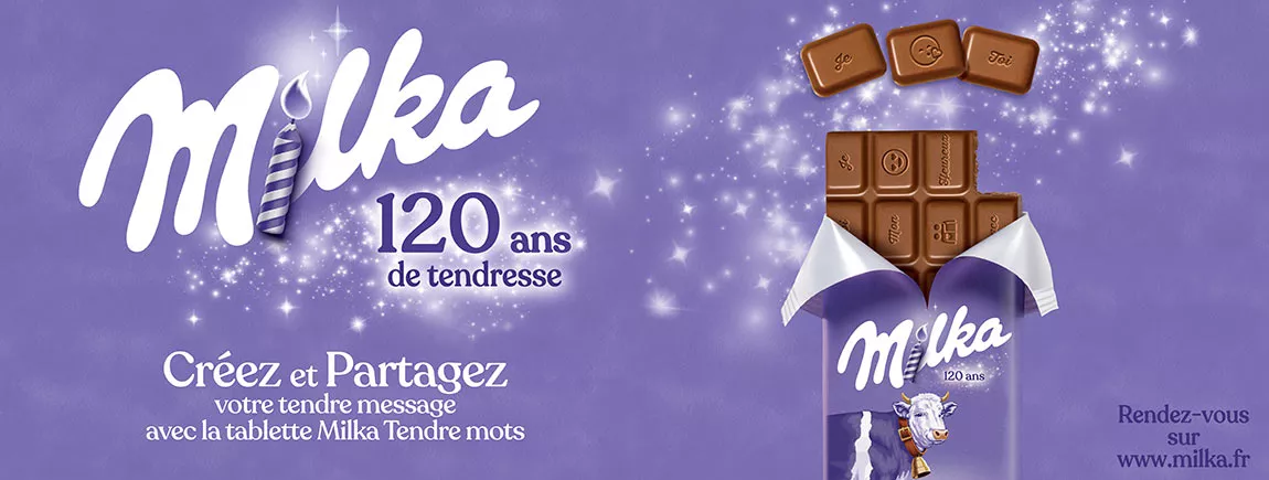 Milka®, 120 ans de tendresse ! Dans un paysage Alpin la vache Milka s’enfuie de la tablette de chocolat.