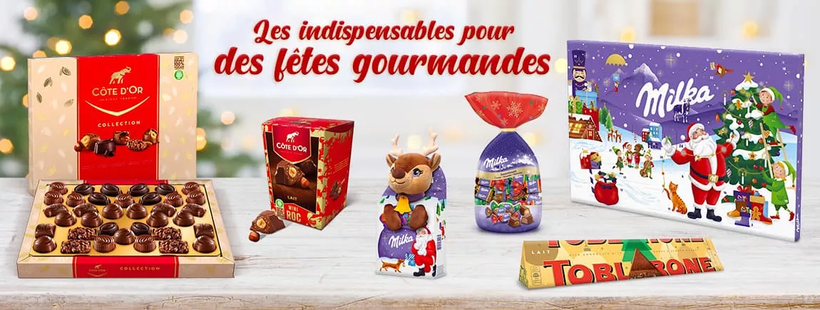 Noël sera riche en saveurs avec Côte d’Or, Milka et Toblerone Sur une table des packs de chocolats Milka Toblerone et Côte d’Or